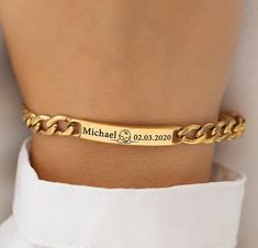 Introducing our Personalized 18K Gold Plated Bracelet - the perfect unisex accessory that captures the essence of life's most precious moments. Whether you're commemorating the birth of a child or celebrating a cherished anniversary, this bracelet is designed to be both meaningful and stylish. The custom engraving of a name, a significant date, and a charming baby symbol makes this piece a unique and sentimental treasure. Crafted with precision, this bracelet features a premium 18K gold plating Gold-colored Stainless Steel Wedding Bracelet, Gold Tarnish Resistant Bracelet For Anniversary, Luxury Engraved Gold Chain Bracelet, Luxury Gold Engraved Chain Bracelet, Engraved Yellow Gold Plated Bracelets, Engraved Yellow Gold-plated Bracelets, Gold Plated Bracelets For Anniversary, Formal Engraved Gold Chain Bracelet, Engraved Yellow Gold Plated Chain Bracelet