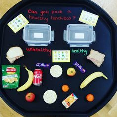 a black tray with food and snacks on it