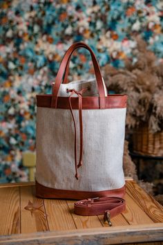 a white and brown bag sitting on top of a wooden table