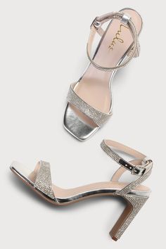 Every fashionable cutie needs a pair of the Lulus Kaylena Silver Rhinestone Ankle Strap High Heel Sandals! A sparkling silver rhinestone construction shapes these party-ready heels that feature a square toe bed with a dainty toe strap. A wrapped blade heel rises to a chic matching ankle strap that wraps around and secures with a shiny silver buckle. 3. 25" wrapped blade heel. Cushioned insole. Rubber sole has nonskid markings. Man Made Materials. Imported. Lulus | Kaylena Silver Rhinestone Ankle Chic Sparkling Sandals For Prom, Formal Bedazzled Ankle Strap Sandals, Glamorous Sparkling Sandals For Prom, Silver Open Toe Sandals With Rhinestones, Silver Sandals With Rhinestones For Events, Bedazzled Ankle Strap Sandals For Party, Elegant Ankle Strap Sandals With Bling, Elegant Silver Bedazzled Sandals, Elegant Bedazzled Silver Sandals