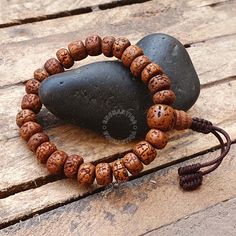 Introducing our exquisite Natural Aged Brown 5 Mukhi Rudraksha Buddhist Bracelet, a harmonious fusion of spiritual significance and timeless elegance. Handcrafted with care, each Rudraksha bead is meticulously sanded in a tumbler, ensuring unparalleled comfort against your skin. The beads are then naturally stained and delicately oiled, revealing a stunning and rich brown hue that accentuates the inherent beauty of these sacred seeds. Our artisans skillfully incorporate an adjustable knot into the design, allowing you to personalize the fit for optimal comfort. The bracelet not only serves as a meaningful accessory but also carries the essence of tradition and mindfulness. 📏Beads Size : 8-8.5 MM  📏Bracelet length: 7.0-7.25 Inches - Adjustable to 2.0 inches The 5 Mukhi Rudraksha beads hol Adjustable Traditional Bracelets For Rituals, Adjustable Fusion Bracelets, Adjustable Brown Bracelet For Festivals, Adjustable Brown Bracelets For Festivals, Traditional Brown Bracelet For Rituals, Traditional Hand Wrapped Brown Bracelet, Traditional Adjustable Bracelet With 8mm Beads, Traditional Hand-wrapped Bracelets For Meditation, Adjustable Bohemian Bracelets For Puja