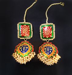 red Green Navy Meena Pearl EARRINGS If you like to make a statement with your jewelry then this is the piece to own Elongated Gold plated Traditional Kundan Earrings **Made in pure .925 sterling silver base and 18 K Gold plated. **Paisley style chandelier earrings, hand enameled with real pearls along the edges with elegant royal hand painted motif an elegant fusion design. **Fresh Water Pearls on the bottom **Length- 3.25 inches and width - 1.2 inch at the widest point These earrings will be sh Multicolor Tilla Jewelry For Gifts, Red Temple Jewelry Style Drop Earrings, Ceremonial Festive Drop Earrings, Bollywood Style Multicolor Jewelry Gift, Traditional Red Drop Earrings, Red Temple Jewelry For Pierced Ears, Festive Ceremonial Drop Earrings, Red Chandbali Jewelry With Latkans, Multicolor Gold Plated Earrings For Festive Occasions