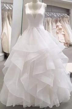 a white wedding dress on display in a store