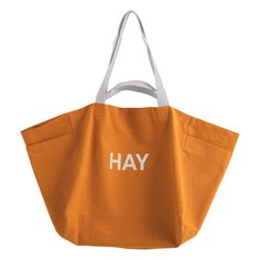 an orange tote bag with the word hay printed in white on it's side