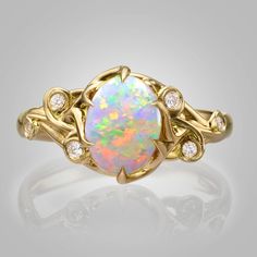 "A handmade 14k gold ring set with a beautiful oval opal and white diamonds. ----> A video is available here - https://youtu.be/Ggt0E_E0iS4 The pictured opal is sold. Opal #1 Dimensions - 7mmX9mmX2.7mm, 1.18ct Australian 1550$ Opal #2 Dimensions - 6.9mmX9mmX3mm, 1.2ct Australian 1300$ Opal #3 Dimensions - 6.8mmX8.7mmX3.1mm, 1.26ct Australian 1650$ Opal #4 Dimensions - 7mmX8.8mmX2.5mm, 0.98ct Australian 1200$ Opal #5 Dimensions - 9.1mmX7.1mmX3.2mm, 1.2ct Australian 1650$ Opal #6 Dimensions - 9.1m Oval Opal Ring, Black Opal Jewelry, Australian Opal Jewelry, Rose Gold Opal Ring, Rose Gold Ring Set, Large Stone Rings, Australian Opal Ring, Engagement Ring Opal, Twig Engagement Ring