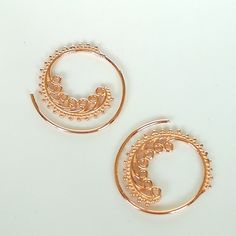 Indian style sterling silver spiral ear hoops. These are dipped in rose gold. Dimensions: 25 mm x 26 mm Price listed is for a pair. These earrings are made of 925 hypoallergenic sterling silver and rose gold All my pieces are sent in a gift box. I can include a personal message from you if needed. You are welcome to contact me at... bhavnakwintra1956@gmail.com More hoops: https://www.etsy.com/your/shops/TheSilverGame/tools/listings/section:26305414 More earrings: https://www.etsy.com/your/shops/ Bohemian Rose Gold Nickel-free Jewelry, Bohemian Rose Gold Jewelry With Ear Wire, Handmade Small Hoop Rose Gold Earrings, Rose Gold Wire Wrapped Hoop Earrings, Bohemian Rose Gold Nickel-free Earrings, Delicate Rose Gold Small Hoop Earrings, Rose Gold Spiral Earrings With Ear Wire, Handmade Dainty Rose Gold Hoop Earrings, Delicate Rose Gold Pierced Hoop Earrings