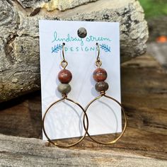 Light and airy hoop earrings are the perfect compliment to your festival style. Hand formed hoops are made with tarnish resistant enameled copper wire in vintage bronze. Accented with a pair of warm and earthy jasper. - Lightweight earrings for everyday wear! - Wire is manufactured in the USA - Earrings dangle 2" long on antiqued gold plated steel wires. Brown Hoop Earrings For Gift, Brown Small Hoop Earrings As Gift, Nickel-free Brown Hoop Earrings As Gift, Brown Hoop Jewelry With Ear Wire, Brown Hoop Earrings With Ear Wire For Gift, Minimalist Brown Hoop Earrings For Gift, Bohemian Small Hoop Copper Earrings, Bohemian Small Copper Hoop Earrings, Small Bohemian Copper Hoop Earrings