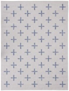 a white rug with blue crosses on it