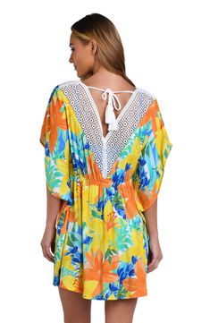 This bright and cheerful floral print has a summery vibe, perfect for a beach day. Styled with breezy dolman sleeves and a flowy fit, this cover-up is finished with crochet trim, braided ties, and thread tassels for a playful touch. [split] Details V-neck caftan Ties at neck Dolman sleeves Braided ties with thread tassels Breezy silhouette Fabric 100% Rayon Crepe V-neck Beach Dress With Lace Trim As Cover-up, V-neck Beach Dress With Lace Trim, Spring Beach Party Cover-up With Crochet Trim, Multicolor V-neck Cover-up For Beach Party, Multicolor V-neck Beach Dress With Floral Print, Summer V-neck Cover-up With Tropical Print, Beachy Multicolor V-neck Cover-up, Floral Print V-neck Cover-up For Vacation, Bohemian V-neck Cover-up With Tropical Print