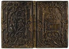 an intricately carved wooden book cover