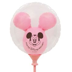 a pink and white mickey mouse balloon on a stick