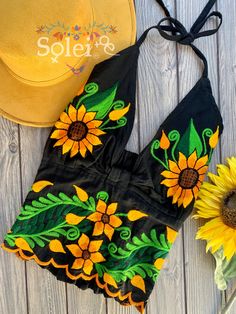 This Beautiful Sunflower Embroidered Halter Top is the perfect Top for Everyday use or a special event. It is comfortable, with elastic on the back and has a tie around the neck for an adjustable fit. This blouse comes in one size which fits sizes Small and Medium. Green Embroidered Top For Summer, Fitted Floral Embroidered Top For Festival, Fitted Floral Embroidered Top For Summer, Fitted Floral Print Embroidered Top For Summer, Summer Embroidered Top With Floral Print, Fitted Summer Embroidered Top With Geometric Design, Fitted Summer Embroidered Top With Geometric Embroidery, Multicolor Embroidered Floral Top For Summer, Fitted Summer Top With Geometric Embroidery