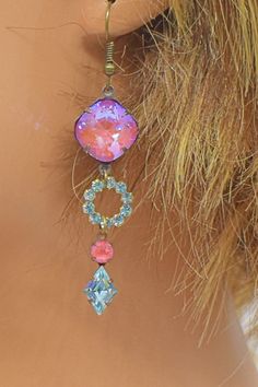 "Pink and blue pastels create such a feminine look.   The pink stones are called electric lotus pink and the blue is aquamarine.  The pink stones are very unique and have a brilliant shine.  These earrings are made up of 3 sections.  First the square shaped pink rhinestone, then the blue round rhinestone drop and finally the combined pink and blue rhinestone drop.  Just lovely.   Arrives nicely packaged and ready for gift giving if desired.  Measurements: The length is 2\" and does not include t Pink Stones, Handcrafted Earrings, Earrings Blue, Pink Rhinestones, Feminine Look, Pink Stone, Blue Rhinestones, Blue And Pink, Wedding Earrings