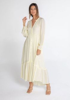 A classic bohemian maxi dress in a billowy silhouette, designed in textured checkered jacquard. This dreamy and versatile style features long voluminous sleeves, a delicate self-covered button front, and a ruffle-trimmed neckline. The tiered skirt adds shape and movement. Try this timeless style unbuttoned over denim! Checkered jacquard Relaxed, flowy fit Long voluminous sleeves Elastic wrist cuffs Maxi length Ruffle-trimmed tiered skirt Ruffle-trimmed round neckline Self-covered button front Si Flowy Maxi Dress Fall, Flowy Bohemian Dress, Shabbat Outfit, Long Sleeved Maxi Dress Fall, Casual Long Sleeve Dresses, Maxi Dress Pattern Sewing, Button Down Maxi Dress, Dusty Teal, Skirt Ruffle