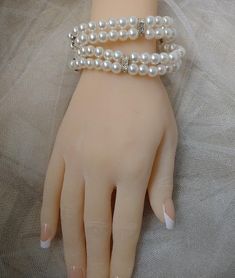 Very pretty white pearl bracelet with rhinestone detail. This is a stretch bracelet that can fit any wrist size. Very comfortable to wear. You get two individual bracelets that have two strands of pearls each. You can wear one at a time or stack both together for a wider bracelet look. This will look great with your wedding gown. Accessorize with pearl earrings, and you are good to go! Elegant Pearl White Stretch Bracelet, Elegant Pearl Stretch Bracelet For Party, White Pearl Embellished Bracelets For Wedding, White Pearl Embellished Bracelet For Party, White Pearl Bracelet For Mother Of The Bride, Elegant Pearl White Stretch Pearl Bracelet, Elegant Pearl White Pearl Stretch Bracelet, Pearl Beaded Stretch Bracelet For Wedding, Elegant White Stretch Bracelet With Pearl Charm