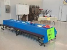 a blue table with signs on it in a room