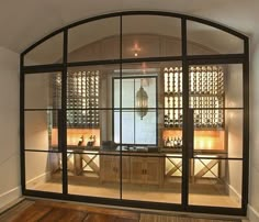 the inside of a wine cellar with glass doors