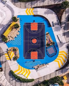 an aerial view of a basketball court in the middle of a swimming pool with palm trees