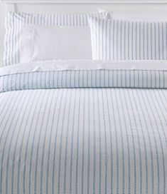 a bed with blue and white striped sheets