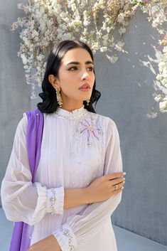 SKU: 2201 Price for Shirt, lining & Pants This immaculately crafted lilac pleated ensemble is all set to make its way to our festive wardrobe. Adorned with glistening pearls, thread, and hand embellished with crystals. This ensemble comes up with a gorgeous double shaded duppatta to complete the look. Dupatta as is can be added to complete this serene outfit. Elegant Purple Evening Sets, Elegant Lavender Festive Sets, Elegant Lavender Sets For Festive Occasions, Elegant Festive Lavender Sets, Elegant Embellished Sets For Celebration, Festive Lavender Long Sleeve Set, Purple Long Sleeve Sets For Evening, Festive Lavender Party Set, Elegant Lavender Dress For Festive Occasions