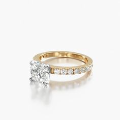 a yellow gold engagement ring with a single diamond in the center and side stones on each band