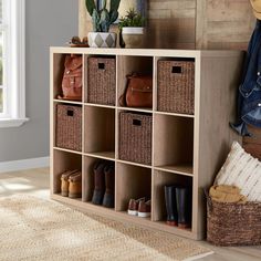 a wooden shelf with baskets and shoes on it