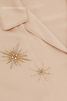 a close up of a jacket with a star brooch on the front and back