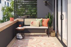 a bench sitting on top of a wooden floor next to a balcony with plants and pillows