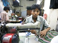 a boy is sitting at a sewing machine with the words how dare you boycott nike when they employ so many children of color