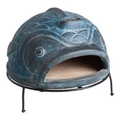 a blue ceramic fish shaped object on a metal stand