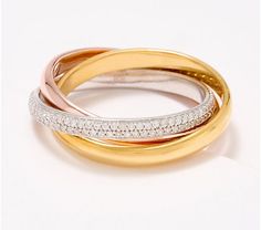 two tone gold and silver rings with diamonds on each ring, set against a white background