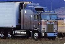 a large semi truck parked in a field