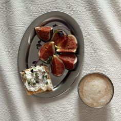 a plate that has some food on it next to a small bowl with something in it