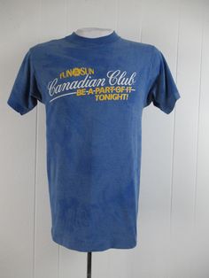 "Vintage 1980s t shirt. Made of blue tie dye style poly/cotton with yellow and white graphics: Canadian Club fun in the sun. Made by Screen Stars. Size medium. Actual measurements are: 37\" around the chest 37\" around the waist 17\" shoulder seam to shoulder seam 27\" overall length In good condition with a couple 1\" spots(photos)." Faded Retro T-shirt For Summer, Canadian Club, 1970s Dresses, Club T Shirt, Hawaiian Dress, Vintage Hawaiian, Blue Tie, Blue Ties, Blue Tie Dye