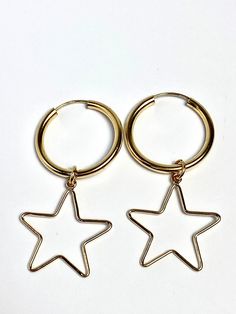 Breathe taking 14KGF hoop with star earrings. A great gift for someone in your life. Price is for per pair of earrings. Below is the measurements for the earrings. Hoop measurements Diameter: 0.84 inches, 21.64 MM Thickness:0.88 inches, 2.26MM Star measurements Diameter: 21.06 inches, 0.829 MM Thickness: 0.038 inches, 0.96 MM 14K gold filled Made in USA We ship in 1 to 3 days from Hawaii by First Class Airmail. Shipping to the USA usually takes 3 to 5 days. We import Tahitian pearls straight fro Gold Star-shaped Hoop Earrings With Ear Wire, Everyday Gold Star-shaped Hoop Earrings, Gold Star Charm Hoop Earrings, Gold Star-shaped Single Hoop Earring, Handmade Gold Star Hoop Earrings, Star-shaped Hoop Earrings For Everyday, Star-shaped Hoop Earrings For Gift, Star Shaped Hoop Earrings Gift, Gold Star-shaped Hoop Earrings