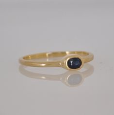 "This is a 18k gold Beautiful ring with a gentle oval blue Sapphire gemstone. That soliter ring is just the perfect stacking ring. Not too big and not too small. You can wear this ring every day and for every occasion. The blue Sapphire color is a perfect harmony with the 18k solid gold. This ring can be the center piece of a set of gold stacking rings. I can set diffrent color of gemstone in this gold ring. Dimensions: Oval Sapphire: 5 m\"m * 3 m\"m You can see other gemstone rings n my shop: h Elegant Sapphire Signet Ring, Timeless Yellow Gold Sapphire Promise Ring, Timeless Gold Sapphire Ring, Elegant Sapphire Signet Ring In Yellow Gold, Elegant Gold Sapphire Ring With Polished Finish, Timeless Gold Sapphire Ring Hallmarked, Elegant Yellow Gold Sapphire Signet Ring, Yellow Gold Sapphire Ring Fine Jewelry, Oval Yellow Gold Sapphire Ring With Bezel Setting