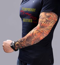 a man with tattoos on his arm holding a cell phone