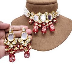 Gold Rodium Polish Red and Maroon color Necklace in Metal Alloy studded with Kundan Red Party Jewelry For Festive Season, Red Bridal Necklace For Party, Red Metal Jewelry Sets For Party, Red Jewelry For Festival Party, Red Kundan Jewelry For Party, Elegant Red Choker For Festivals, Festive Red Metal Jewelry, Red Kundan Necklace For Festive Party, Red Kundan Necklace For Party And Festive Season