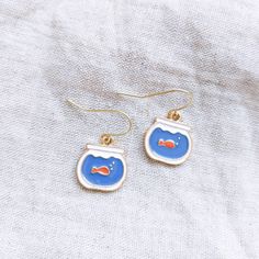 Handmade with love in Montreal, Canada.  These adorable goldfish in a bowl earrings are the perfect addition to any outfit in any season! Treat yourself or someone you love.  Made in Montreal. Suitable for sensitive ears, nickel-free. *FREE DOMESTIC SHIPPING DOES NOT INCLUDE TRACKING.* For a tracked parcel, please select Xpresspost or Priority at checkout PLEASE NOTE: Free domestic shipping DOES NOT include tracking nor insurance. If you would like a tracked package and insurance, you must selec Kawaii Gold Nickel-free Jewelry, Playful Drop Earrings With Ear Wire, Kawaii Nickel-free Gold Jewelry, Gold Nickel-free Kawaii Jewelry, Playful Jewelry Set With Drop Earrings, Playful Jewelry Set With Matching Drop Earrings, Playful Gold Hypoallergenic Earrings, Playful Hypoallergenic Gold Earrings, Cute Nickel-free Hoop Earrings For Gift