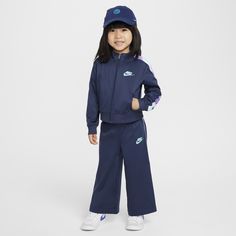 Put your little athlete in this performance tracksuit, made of soft pique knit fabric enhanced with quick-drying, moisture-wicking Dri-FIT technology to help keep them cool and dry while they play. The jacket has a full-zip closure and a roomy cut that make layering easy, and pockets at the sides come in handy for stashing small items. The matching pants have a stretch waistband that provides a comfy fit. Pair with any Nike tank or tee for a completed look. Nike Moisture-wicking Sportswear Track Jacket, Nike Moisture-wicking Track Jacket, Sporty Blue Sets For Sports Events, Navy Nike Activewear For The Gym, Nike Sportswear Tracksuit For Sports, Sporty Hooded Sports Set, Functional Moisture-wicking Tracksuit For Training, Sporty Hooded Sportswear Set, Nike Navy Athleisure Activewear