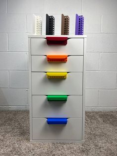 a multicolored file cabinet with legos on the top and bottom drawers in different colors