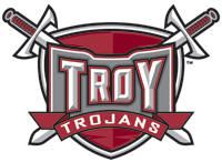 the troy trojans logo is shown in red and grey with two swords on it