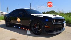 a police car parked in front of a stop sign