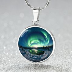 Embrace the mystique of the wilderness with our Personalized Aurora Wilderness Lovers Necklace.  This Personalized Aurora Wilderness Lovers Necklace will make a great gift for her; be it Christmas, Valentine's, Mother's Day, a Birthday, Anniversary, or as a memento to mark a trip to Alaska, Iceland, Sweden, wherever your aurora hunting journey took you, or will take you. Maybe your loved one dreams of seeing the northern lights right here in the Lower 48 as has been happening recently, or is an Collectible Mystical Necklace, Collectible Mystical Round Necklace, Mystical Round Engraved Jewelry, Mystical Engraved Round Pendant Jewelry, Nickel-free Mystical Round Necklaces, Nickel Free Round Mystical Necklace, Nickel-free Round Mystical Necklace, Artistic Nickel-free Round Jewelry, Mystical Pendant Jewelry Gift