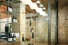 there is a wine rack in the middle of this room with many bottles on it