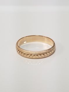 "Thanks for shopping our vintage estate store. We tend to sell well below wholesale and truly hope you enjoy all of our items. Many of the items are one of a kind, so please enjoy scrolling through the pictures and hopefully something will catch your eye. Brown spots are from the camera's reflection. Nice estate 14k yellow gold wedding band edged diamond cut design. Ring size: 6 Width: 4mm 3/16\" Weight: 2.46 grams Marked 14k as all our gold is marked or tested. We do not sell gold plated items. Classic Yellow Gold Band With Intricate Design, Gold Milgrain Bands For Anniversary, Heirloom 14k Gold Diamond Cut Band, Heirloom Round Bands With Milgrain Detail, Heirloom 14k Gold Band With Diamond Cut, Heirloom Milgrain Bands For Anniversary, Heirloom Rings With Decorative Band, Heirloom 14k Gold Ring With Decorative Band, Classic Intricate 14k Gold Jewelry