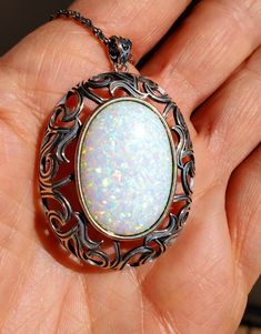 "Huge White Opal Vintage Style Necklace, 18x25mm Lab Created Favorite Opal With Rainbow Fire, See Video! Antiqued Sterling Pendant, 20\" Chain. Gift Box Included. This Is For The Lover Of Bold Jewelry, It Is Quite Large!" Elegant White Necklace With Large Stone, Elegant White Necklaces With Large Stone, White Oval Cabochon Necklace, White Ornate Handmade Jewelry, White Handmade Ornate Jewelry, Ornate Handmade White Jewelry, Ornate White Handmade Jewelry, Ornate Oval Necklace With Large Pendant, White Ornate Jewelry For Jewelry Making