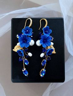 Dark blue earrings are light and ellegant. Earring length about 3 inches. The clasp on the earrings is made of hypoallergenic metal. Dark blue flower earrings consist of ceramic pearls, crystal rhinestones, crystal beads, polymer clay flowers, jewelry wire. * All orders from the Exclusive Wedding Shop you will receive in a FREE beautiful gift box. * Standard shipping: - USA: 12-15 business days - Europe: 3-5 weeks - Canada: 6-10 weeks - Australia: 6-10 weeks - Rest of World: 4-10 weeks * Express Blue Earrings Wedding, Royal Blue Earrings, Blue Flower Earrings, Ethereal Jewelry, Dark Blue Earrings, Navy Blue Earrings, Quilled Creations, Crystal Earrings Wedding, Anime Jewelry