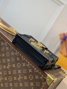 a louis vuitton suitcase sitting on top of a table