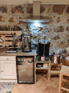 a kitchen with an oven, stove and various cooking utensils on the counter